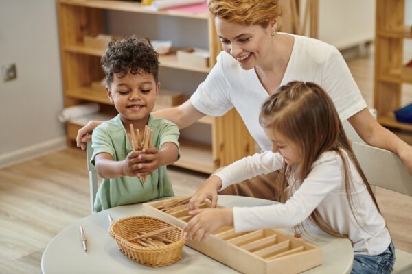 Montessori teacher with two students.